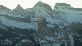 HD stock footage aerial video of snowy Rocky Mountains and a rock formation at sunrise, Colorado Aerial Stock Footage | HDA13_403_03