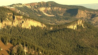 HDA13_403_06 - HD stock footage aerial video of mountain ridges and evergreen trees at sunrise in Rocky Mountains, Colorado