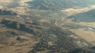 HDA13_424 - HD stock footage aerial video of approaching the town of Gunnison at sunrise, Colorado