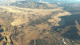 HDA13_427 - HD stock footage aerial video tilt from Gunnison to reveal farms and mountains at sunrise, Colorado