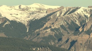 HD stock footage aerial video of flying by the Rocky Mountains at sunrise with snow, Colorado Aerial Stock Footage | HDA13_431