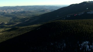 HD stock footage aerial video of flying over trees and on mountains with snow patches in the Rocky Mountains, Colorado Aerial Stock Footage | HDA13_475