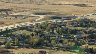 HD stock footage aerial video of a freeway interchange beside a suburban neighborhood in Castle Pines, Colorado Aerial Stock Footage | HDA13_486_02