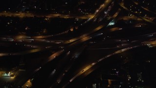 LD01_0047 - 5K aerial stock footage orbit of a freeway interchange at night in West Los Angeles, California