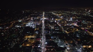 LD01_0074 - 5K aerial stock footage tilt from hotels and theaters up Hollywood Boulevard at night, Hollywood, California