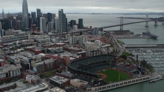 5.7K stock footage aerial video flying by AT&T Park, tilt to city skyline in background, Downtown San Francisco, California Aerial Stock Footage | PP0002_000016