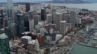 5.7K stock footage aerial video tilt from skyscrapers in Downtown San Francisco, California to reveal Embarcadero and Bay Bridge Aerial Stock Footage | PP0002_000041