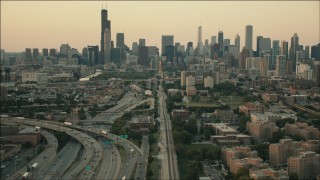 HD aerial stock footage of tilting from train tracks to reveal the skyline at sunset, Downtown Chicago, Illinois Aerial Stock Footage | PP001_024