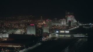 HD stock footage aerial video of beachfront hotels and casinos at night in Atlantic City, New Jersey Aerial Stock Footage | PP003_019