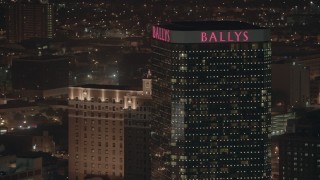 PP003_021 - HD stock footage aerial video of flying by the top of a hotel and casino at night, Atlantic City, New Jersey