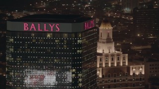 HD stock footage aerial video of passing the top of a hotel and casino at night in Atlantic City, New Jersey Aerial Stock Footage | PP003_022