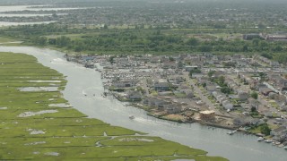 HD stock footage aerial video of approaching riverfront homes in Seaford, New York Aerial Stock Footage | PP003_039