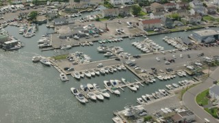 HD stock footage aerial video fly over riverfront homes and a marina in Seaford, New York Aerial Stock Footage | PP003_040