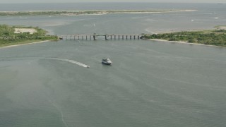 PP003_047 - HD stock footage aerial video of approaching a ferry and a bridge in Point Lookout, New York