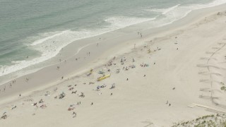 HD stock footage aerial video of approaching sunbathers on the beach, Lido Beach, New York Aerial Stock Footage | PP003_051