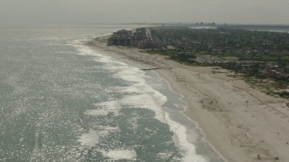 HD stock footage aerial video of tilting from sunbathers on the beach to the Lido Beach coastal community in New York Aerial Stock Footage | PP003_052