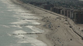 HD stock footage aerial video of beach-goers near the boardwalk in Long Beach, New York Aerial Stock Footage | PP003_055