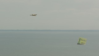 PP003_056 - HD stock footage aerial video of an airplane with an advertising banner in Long Beach, New York