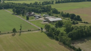 HD stock footage aerial video of fly over fields to approach barns at a farm in Jackson, New Jersey Aerial Stock Footage | PP003_076