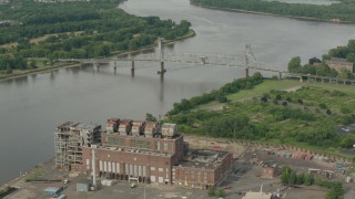 HD stock footage aerial video orbit power plant to reveal a bridge spanning the river in Burlington, New Jersey Aerial Stock Footage | PP003_083