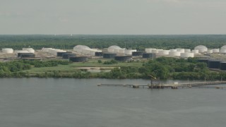 PP003_094 - HD stock footage aerial video of flying by riverfront oil refinery and tanker in Westville, New Jersey