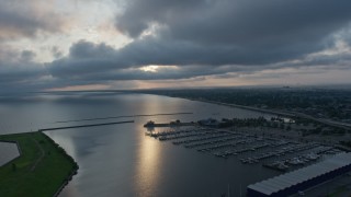 PVED01_001 - 4K aerial stock footage of Lake Pontchartrain and a marina at sunrise, New Orleans, Louisiana