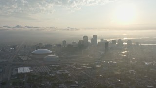 4K aerial stock footage of Downtown New Orleans and Superdome with view of rising sun, Louisiana Aerial Stock Footage | PVED01_008