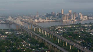 PVED01_016 - 4K aerial stock footage orbit Crescent City Connection Bridge and Downtown New Orleans at sunrise, Louisiana