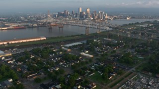 4K aerial stock footage tilt from cemetery to reveal Crescent City Connection and Downtown at sunrise, Louisiana Aerial Stock Footage | PVED01_017