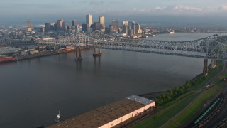 4K aerial stock footage tilt to reveal Crescent City Connection and Downtown New Orleans at sunrise, Louisiana Aerial Stock Footage | PVED01_018