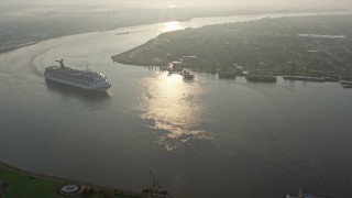 4K aerial stock footage Carnival Cruise ship on the river to reveal Downtown New Orleans at sunrise, Louisiana Aerial Stock Footage | PVED01_029E