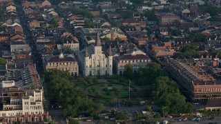 PVED01_035 - 4K aerial stock footage reverse view of St. Louis Cathedral and Jackson Square in the French Quarter of New Orleans at sunrise, Louisiana