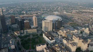 4K aerial stock footage orbiting the Superdome in Downtown New Orleans, Louisiana at sunrise Aerial Stock Footage | PVED01_041E