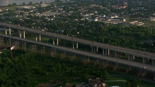 PVED01_046E - 4K aerial stock footage flyby Crescent City Connection Bridge and reveal Downtown New Orleans skyline at sunrise, Louisiana