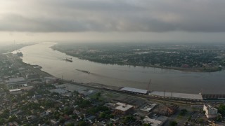 4K aerial stock footage of a wide orbit of barges on the Mississippi River by the French Quarter of New Orleans at sunrise, Louisiana Aerial Stock Footage | PVED01_057