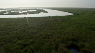 4K aerial stock footage tilt and fly low over marshland and bayou in St. Bernard Parish, Louisiana at sunrise Aerial Stock Footage | PVED01_071