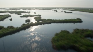 4K aerial stock footage fly low over marshland and bayou to reveal surge barrier at sunrise in St. Bernard Parish, Louisiana Aerial Stock Footage | PVED01_072E