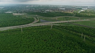 4K aerial stock footage fly over freeway interchange to approach a New Orleans East suburb at sunrise, Louisiana Aerial Stock Footage | PVED01_084E