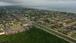 4K aerial stock footage approach suburban neighborhoods by the lake at sunrise in New Orleans East, Louisiana Aerial Stock Footage | PVED01_088