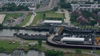 PVED01_096 - 4K aerial stock footage orbit pumping station on 17th Street Canal in Metairie, New Orleans, Louisiana