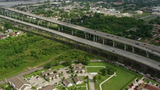 PVED01_113E - 4K aerial stock footage flyby Crescent City Connection Bridge and reveal Downtown New Orleans skyline, Louisiana