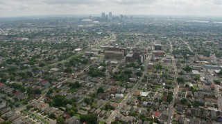 4K aerial stock footage tilt from Uptown suburbs to reveal Downtown New Orleans skyline, Louisiana Aerial Stock Footage | PVED01_154