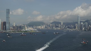 SS01_0010 - 5K stock footage aerial video fly over Victoria Harbor to approach skyscrapers in Kowloon and Hong Kong Island in China