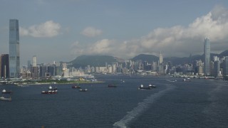 5K stock footage aerial video approach Hong Kong Island waterfront skyscrapers from Victoria Harbor in Hong Kong, China Aerial Stock Footage | SS01_0011