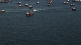 SS01_0012 - 5K stock footage aerial video approach a ferry sailing by cargo ships on Victoria Harbor in Hong Kong, China