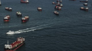 5K stock footage aerial video fly over cargo ships and derry on Victoria Harbor in Hong Kong, China Aerial Stock Footage | SS01_0013