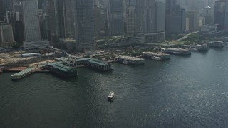 5K stock footage aerial video flyby piers and tilt to skyscrapers on Hong Kong Island, China Aerial Stock Footage | SS01_0014