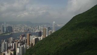 5K stock footage aerial video approach skyscrapers on Hong Kong Island from green mountains, China Aerial Stock Footage | SS01_0039