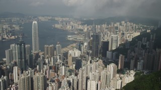 5K stock footage aerial video approach and pan across Hong Kong Island skyscrapers seen from green mountains, China Aerial Stock Footage | SS01_0041