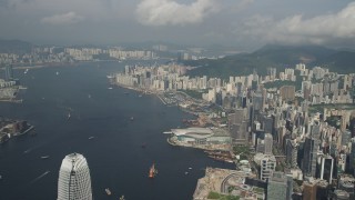 5K stock footage aerial video of Victoria Harbor and waterfront convention center on Hong Kong Island, China Aerial Stock Footage | SS01_0044